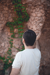 Obraz na płótnie Canvas Man looking at rock wall