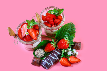 strawberry dessert. Chocolate cookies, cream and strawberry desserts in glass. Isolated on pink background. top view, free space for text
