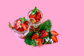 Sweet dessert in glass with cream and strawberry Isolated on pink background. top view, free space for text