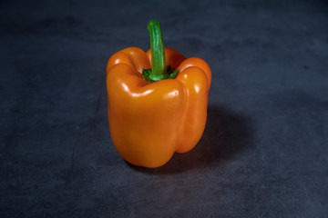 Orange pepper on stone