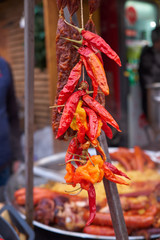 dried red chili peppers, in front of cooking Buncek in Zagreb market
