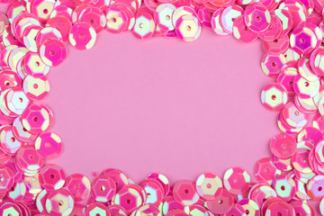 frame from  beads for decoration on a pink background