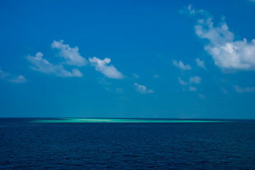 The islands and atolls of the Maldives in the tropical waters of the Indian Ocean
