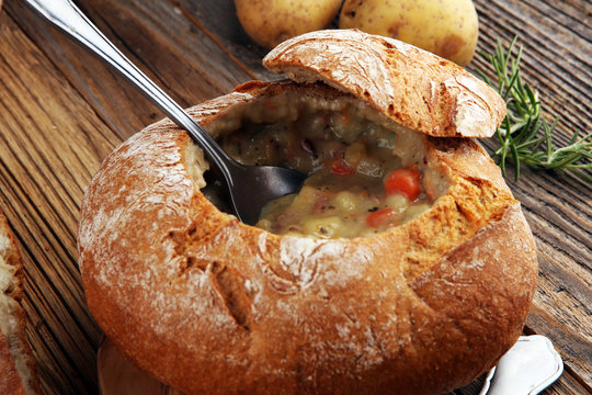 Homemade potato cream soup, served in bread bowl.