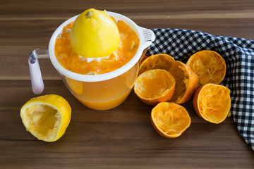 Fresh orange juice and lemonade in glasses.orange and lemon are a vitamin C store. Drinking natural fruit juice for healthy living. the woman squeezes fruit.