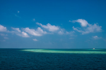 The islands and atolls of the Maldives in the tropical waters of the Indian Ocean