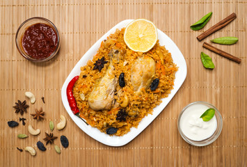 Traditional Indian chicken Biryani with nuts and raisins as close-up.
