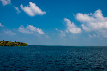 The islands and atolls of the Maldives in the tropical waters of the Indian Ocean