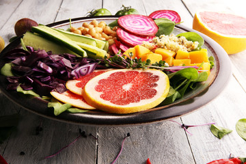 Bowl of Buddha, The concept of a healthy diet: chickpeas, salad, beetroot, pumpkin, cucumber, grapefruit, cabbage and tabouleh. Balanced food.