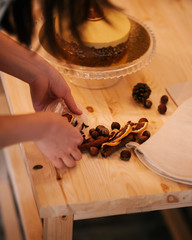 Chef decorates the cake with nuts and orange