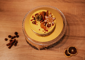 Christmas cake with oranges and nuts on a wooden background. Raw dessert