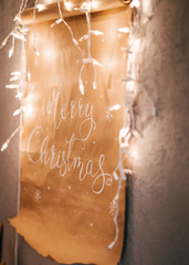 Christmas poster with text on the wall with garland