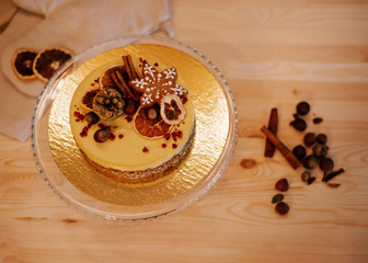 Christmas cake with oranges and nuts on a wooden background. Raw dessert