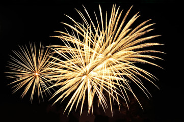 Flashes of  gold fireworks on black background