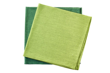 Two green folded textile napkins on white
