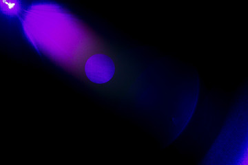 Camera lens flare by laser light create circles of objective and interference effect and moire on digital sensor on dark black background