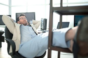 relaxing businessman sitting at his Desk