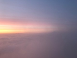 Fototapeta na wymiar abstract pink blue and yellow sky at sunrise above the clouds