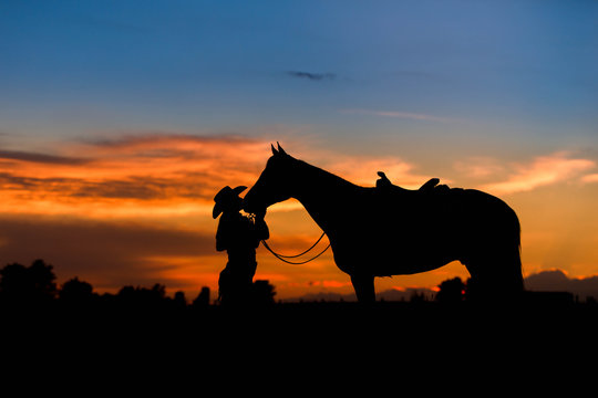 Woman Kissing Horse in Silhouette