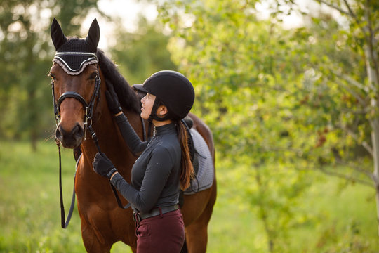 Side view of woman touching horse outdoors