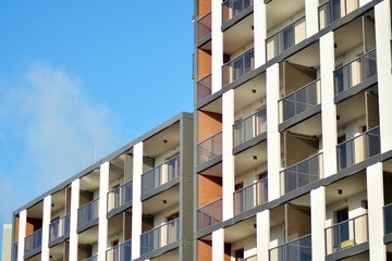 Modern apartment buildings on a sunny day with a blue sky. Facade of a modern apartment building