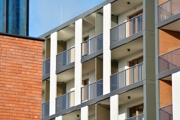 Modern apartment buildings on a sunny day with a blue sky. Facade of a modern apartment building