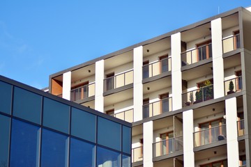 Modern apartment buildings on a sunny day with a blue sky. Facade of a modern apartment building