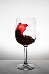 red wine splashing in glass