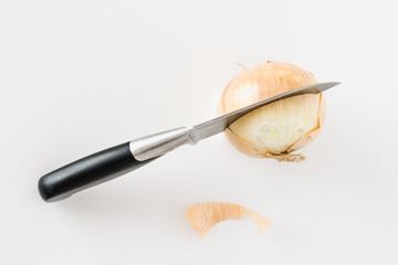 Knife Slicing into an Onion with Its Skin