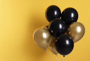 Different helium party balloons on color background. Space for text