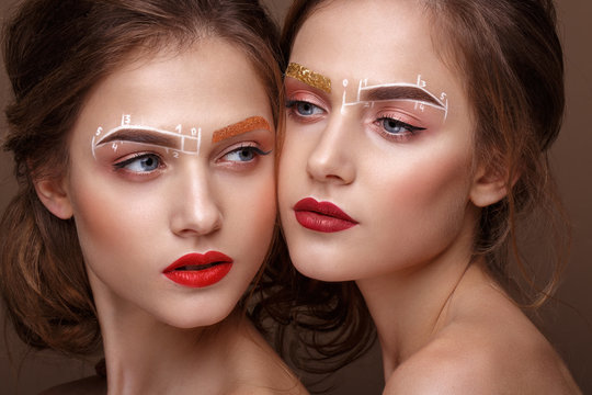 Two girls are twin sisters with an unusual eyebrow makeup. Beauty face.
