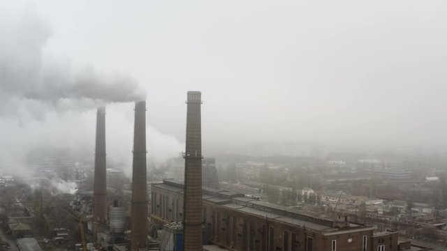 Coal Electricity Power Plant Factory producing Massive Smoke Stack Pollution fumes.