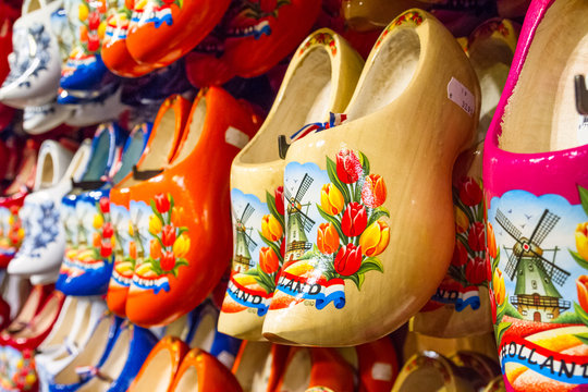 Rack in the store with rows traditional dutch wooden shoes - klompen (clogs), closeup, the Netherlands