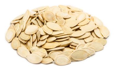 Handful of pumpkin seeds in the shell, close up, isolated on white background