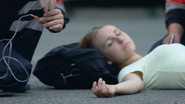 Mass tragedy, paramedics assisting wounded people right on street, emergency