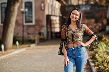 Fototapeta premium Pretty latino model girl from Ecuador wear on jeans posed at street.