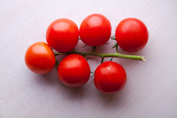 Avocados, tomatoes, lemon on a gray wooden background