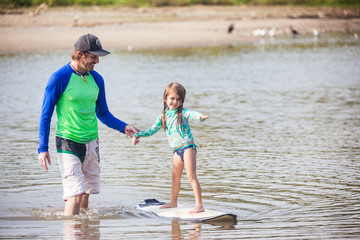 Surfschool, Father shows daughter how to surf
