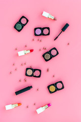 decorative cosmetics on woman desk pink background top view