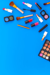 decorative cosmetics on woman desk blue background top view mockup