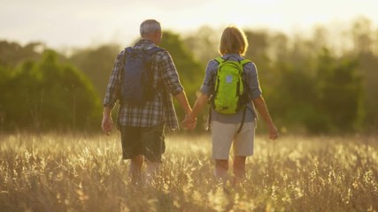 Carefree Caucasian American seniors in casual clothing on a hike in the countryside outdoors 