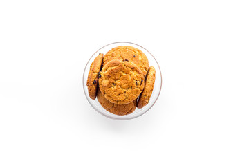 Homemade oatmeal cookies in glass bowl on white background top view copy space