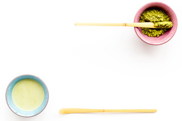Fototapeta na wymiar Japanese matcha tea ceremony concept. Matcha powder, ready matcha tea, accessories on white background top view copy space