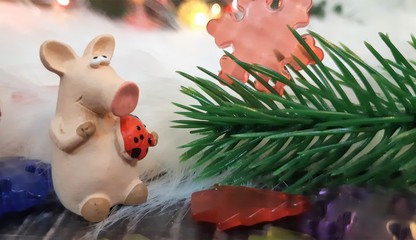 Toy pig and winter decor, congratulations on the holiday. Symbol of the year of the pig on the background of Christmas lights