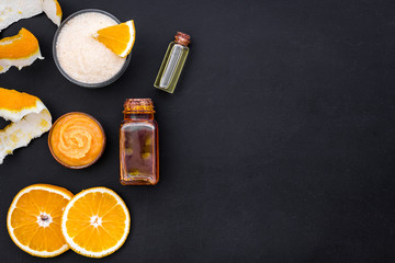 organic cosmetics for homemade spa with orange oil black background top view mockup