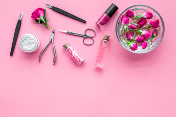 tools for manicure with spa salt and rose on pink background top view mockup