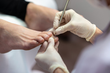 Closeup view of beautician making pedicure