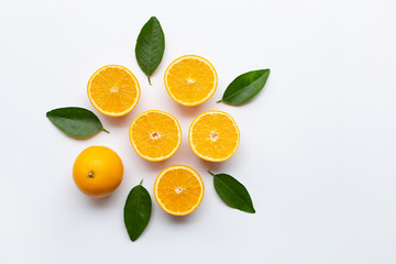 Top view of orange fruits with green leaves isolated on white