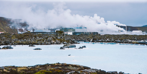 Lake with high amount of dissolved mineral salts and thermal power plant in the background, blue lagoon.