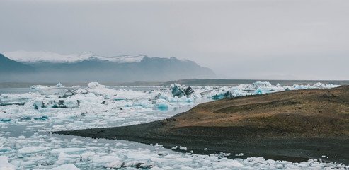Huge blocks of ice on Glacial river and blue icebergs on Jokulsarlon glacier lake. Vatnajokull National Park, Iceland.